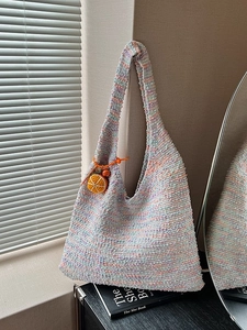 Rainbow woven crochet tote bag with colorful knit pattern and orange slice charm