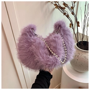 Detail of lavender faux fur handbag with stylish large silver beaded shoulder chain