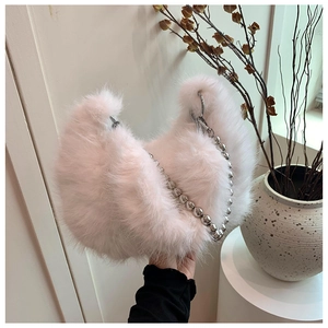 Close-up of soft plush crescent bag with decorative large silver bead chain strap