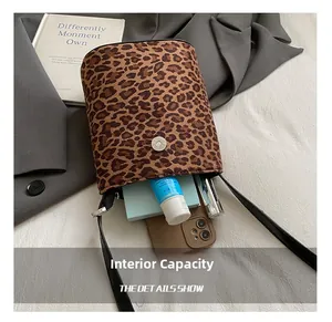 Detailed interior of leopard print bucket bag showing capacity for phone and essentials