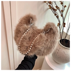 Close-up of fuzzy plush bag texture with silver bead chain and elegant indoor decor
