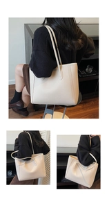 Detail of minimalist cream tote bag showing grainy leather texture and dual shoulder straps