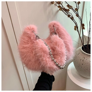 Detail of pink faux fur handbag showing soft texture and silver beaded chain strap