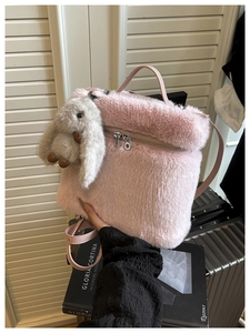 Détail du sac seau en fausse fourrure rose avec une texture douce et un lapin en peluche