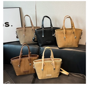 Detailed group view of textured woven bucket bags in five stylish neutral colors