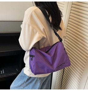 Detail of purple checkered crossbody bag with adjustable strap and Mountain Line text