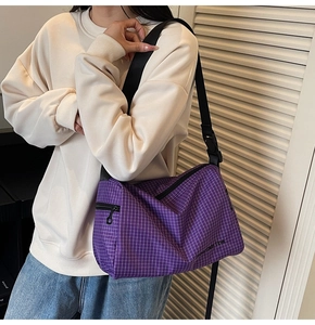 Detail of purple plaid canvas bag with mountain line print and adjustable strap