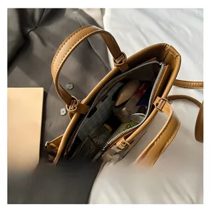 Internal capacity of tan woven tote bag showing space for phone and cosmetics