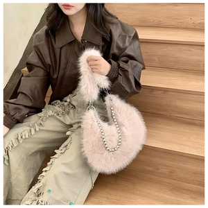 Detail of plush pink faux fur bag with silver beaded chain strap and metal ring buckle