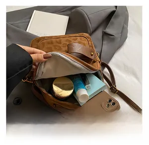 Detail view of mini leopard print backpack interior showing daily essentials capacity