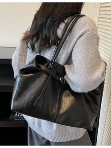 Classic black leather tote bag for women featuring a spacious interior for daily commute