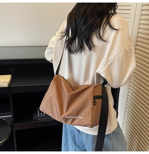 Brown plaid canvas crossbody bag with adjustable wide strap and Mountain Line logo
