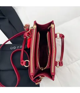 Detail view of red lychee leather tote bag interior with three functional compartments