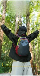 Detail of color-block hiking backpack showing side mesh pocket and durable nylon fabric