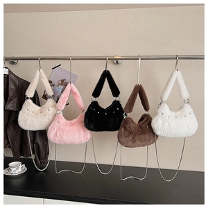 Detail of colorful plush hobo bags with metal star studs and silver chain straps