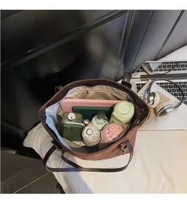 Spacious interior of a brown suede tote bag showing tablet and daily essentials