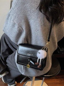 Retro black crossbody square bag with plush pendant and metal logo detail
