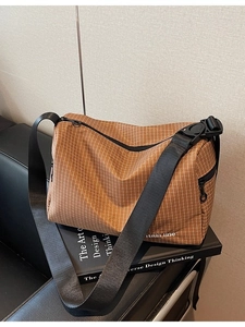 Plaid canvas crossbody bag with adjustable shoulder strap and mountain line text