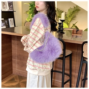 Detail of purple faux fur shoulder bag with elegant pearl chain and silver ring accent