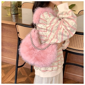 Close-up of pink faux fur shoulder bag with decorative silver metal bead chain strap