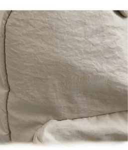 Close-up of the beige woven textile material showing lightweight and natural fabric texture