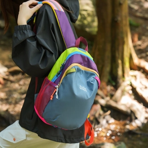 Macro view of multi-color hiking backpack details with zipper and mesh side pocket