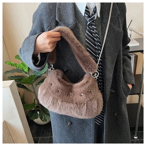 Detail view of brown faux fur crossbody bag with chain strap and stud embellishments