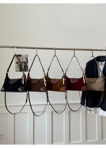 Detail view of suede patchwork crossbody bags in five colors with resin bead charms