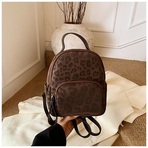 Close-up of leopard print backpack with suede texture and metal zipper details