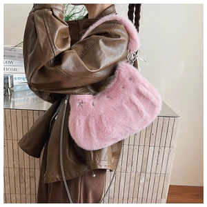 Pink faux fur hobo shoulder bag with fluffy texture and silver rings shown on a model