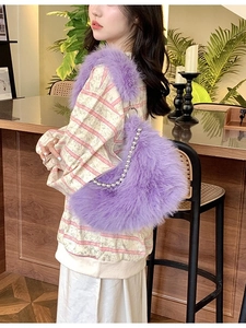 Plush purple faux fur hobo bag with silver beaded chain shown as an underarm bag