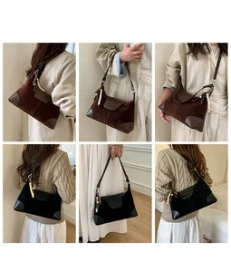 Detail view of suede mini crossbody bag in black and brown with ethnic beaded charms
