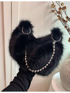 Black plush faux fur shoulder bag with silver ring handles and decorative beaded chain