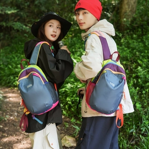 Detail view of colorful outdoor backpacks showing nylon material and brand stitching
