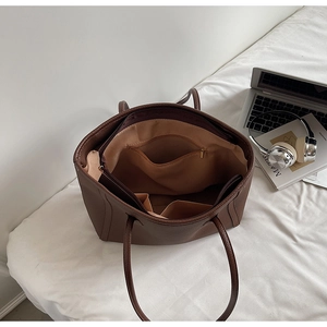 Internal structure of coffee brown tote bag with zipper pockets and litchi grain leather