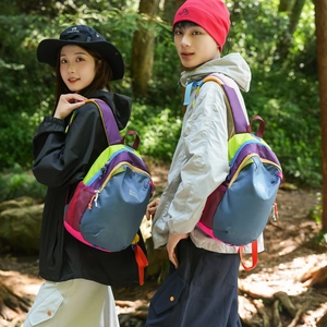 Outdoor hiking backpack with vibrant color-blocking design and mesh side pockets
