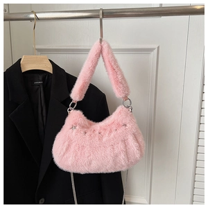 Detail of pink faux fur shoulder bag featuring silver star studs and elegant chain strap