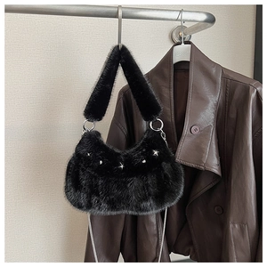 Detail of black faux fur shoulder bag with silver star buckle and metal chain strap