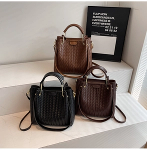 Detailed view of three woven leather tote bags in black brown and coffee colors