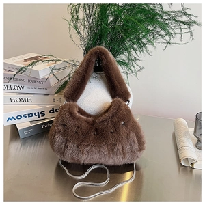 Detail of plush faux fur shoulder bag with silver metal chain strap and star accents