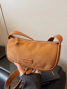 Retro brown suede and leather shoulder bag with embossed logo and zipper closure
