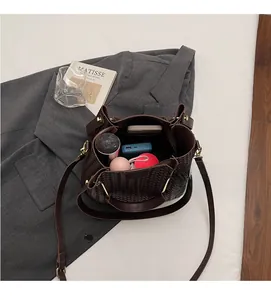 Top view showing the spacious interior of a woven bucket bag with daily essentials