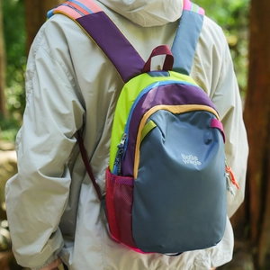 Detail of ergonomic padded shoulder straps on a colorful lightweight hiking backpack