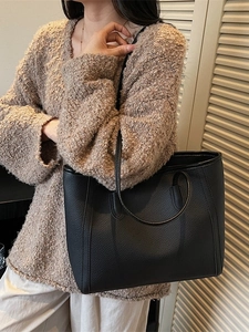 Chic black litchi grain tote bag with dual straps shown on a model for casual commuting