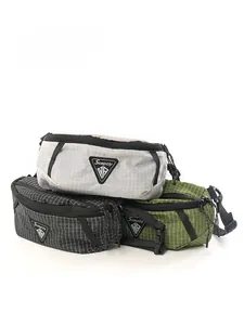 Three outdoor crossbody chest bags in grey, black and green with grid ripstop texture