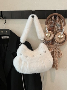 White faux fur shoulder bag with silver star accents and metal chain strap for winter