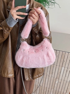 Pink plush crossbody bag with silver star charms and versatile chain strap styling