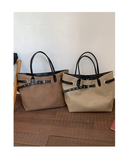 Detail showing high-quality canvas fabric texture and metallic eyelets on the tote bag