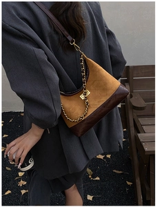 Detail of vintage color-block crossbody bag with gold chain strap and quilted leather