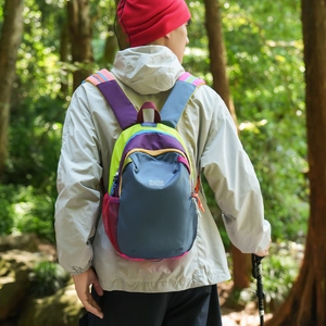 Outdoor view of waterproof color-block backpack worn during a forest hike